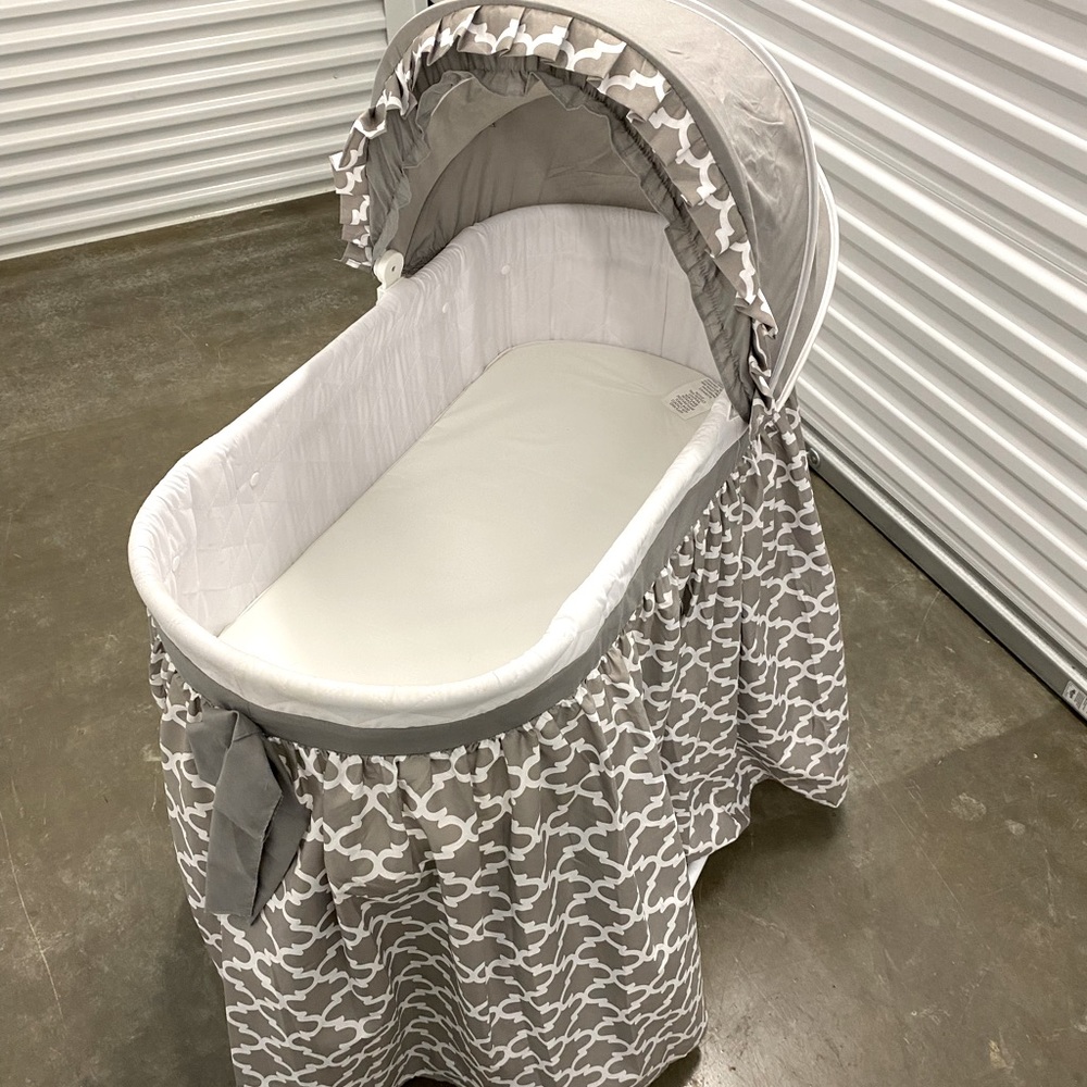 Gray Roller Baby Bassinet with storage underneath